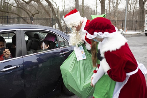 Santa giving toys to family in our drive thru holiday toy shop 