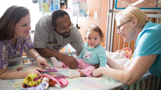 Parents with child and nurse