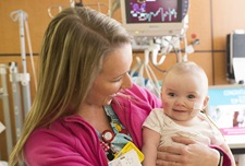 Woman holding a baby in a hospital