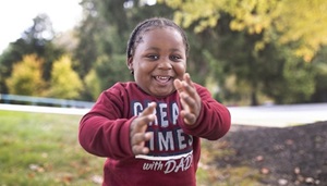 Young boy smiling outside