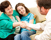 Allied Health image of doctor talking to child patient and parent or guardian