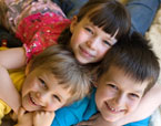 Nursing careers image of three children hugging and smiling