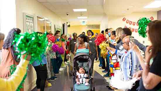 Kiera Robinson leaves Mt. Washington Pediatric Hospital with her daughter, Londyn.